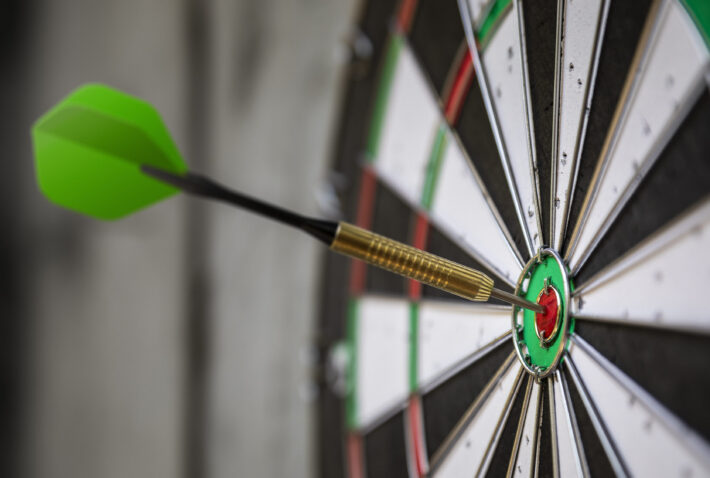 a typical darts game with dart in the bullseye